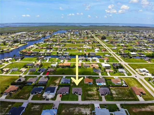 Aerial view of residential area featuring a large body of water