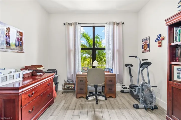 Office space with light wood-style flooring and baseboards