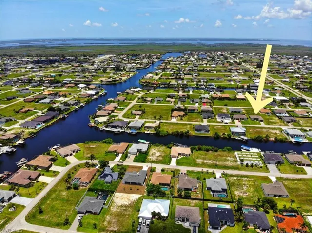 Aerial view of residential area featuring a nearby body of water