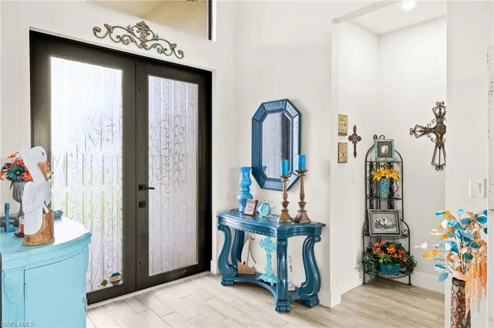 Entryway with french doors and wood finished floors