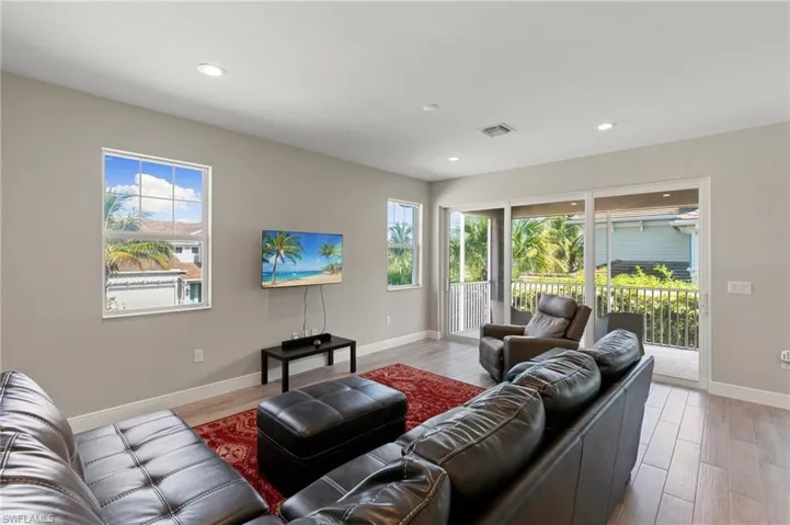 Living area featuring light wood-style floors and recessed lighting