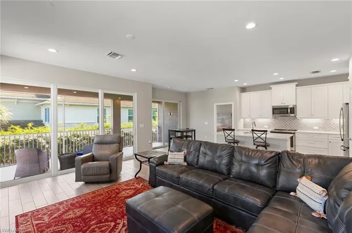 Living room with recessed lighting and wood finished floors