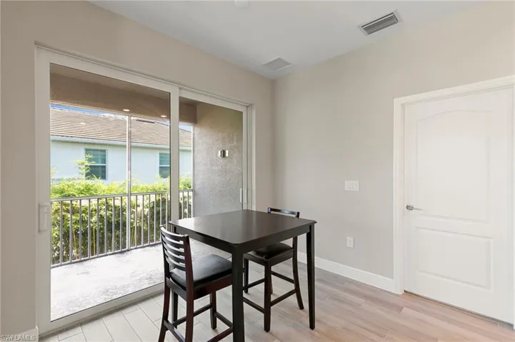 Dining area with light wood-style floors and baseboards