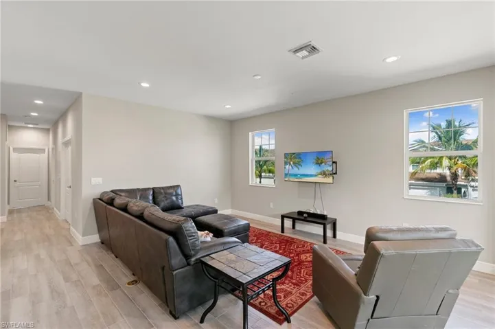 Living room with recessed lighting and light wood-style floors