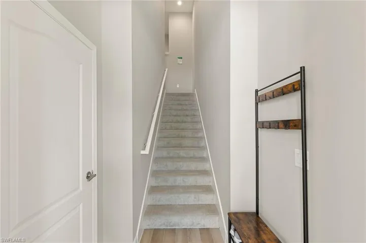 Stairway with baseboards and wood finished floors