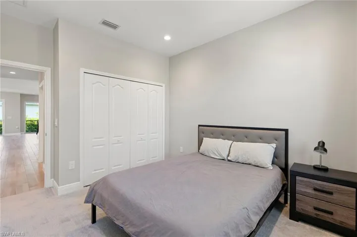 Bedroom featuring recessed lighting and a closet