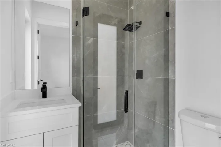 Full bathroom with a shower stall and vanity