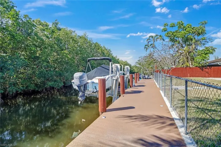 Dock featuring a water view and boat lift