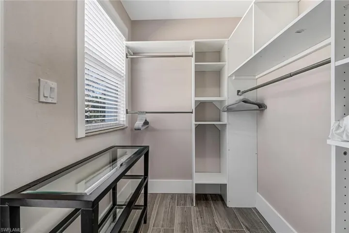 Walk in closet featuring wood finish floors
