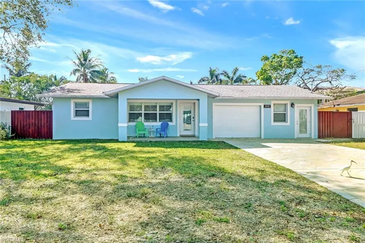 Single story home featuring stucco siding, driveway, a garage, roof with shingles, and a patio area