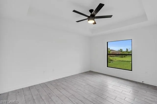 Recessed ceiling with an integrated black ceiling fan and light fixture
