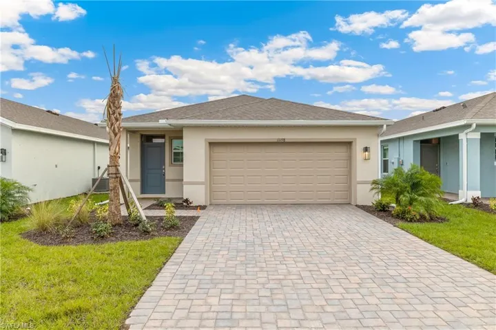 Ranch-style house with a front yard, central AC, and a garage