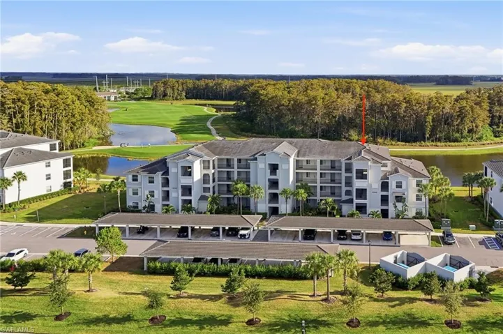 Drone / aerial view of apartment complex / building and a nearby body of water