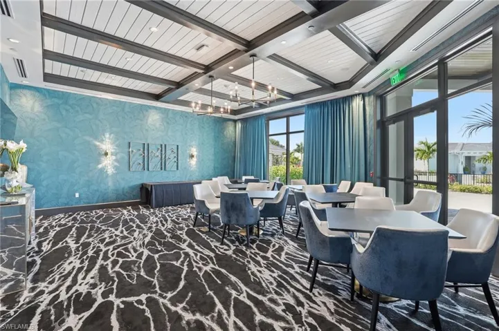 Dining room featuring coffered ceiling, beamed ceiling, wallpapered walls, and a chandelier