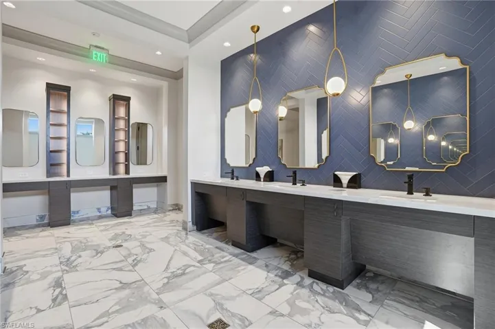 Clubhouse bathroom with double vanity and recessed lighting