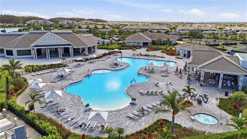 Community pool with a patio, a community hot tub, and a residential view