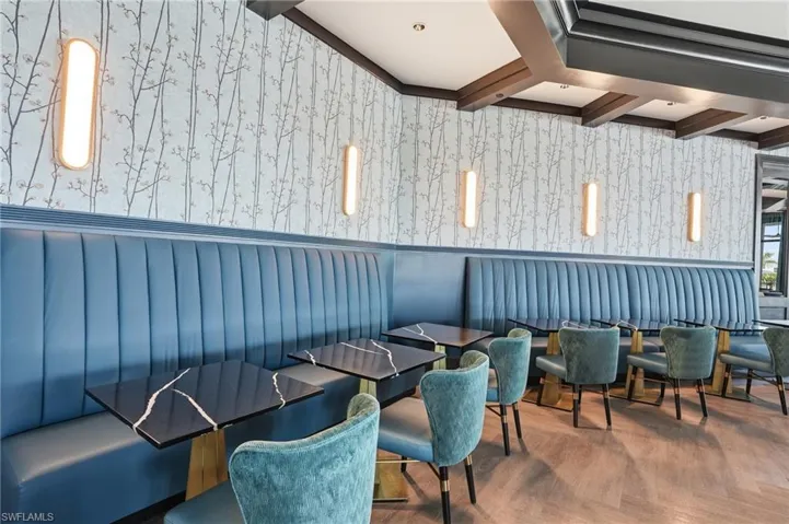 clubhouse dining with wallpapered walls and beamed ceiling