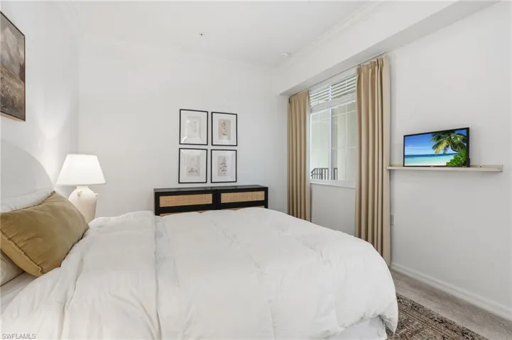 Bedroom featuring ornamental molding and carpet flooring