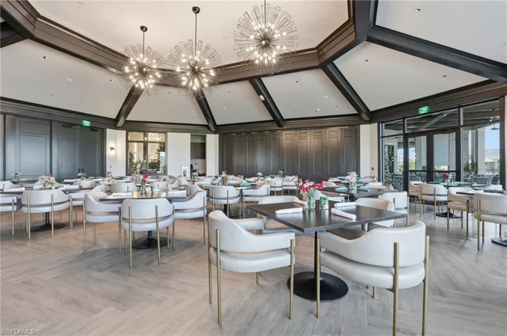 Dining area with a chandelier and a towering ceiling