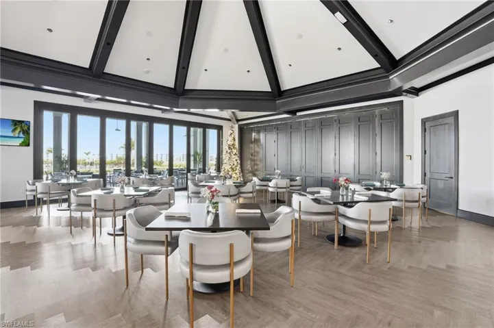 Dining area with a high ceiling and beamed ceiling