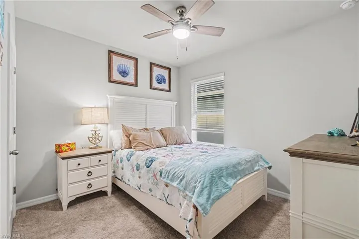 Bedroom featuring light colored carpet and a ceiling fan