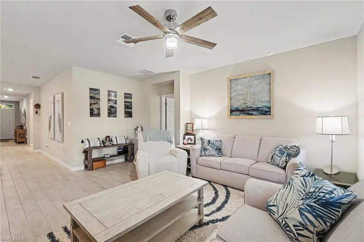 Living area featuring a ceiling fan and wood finished floors