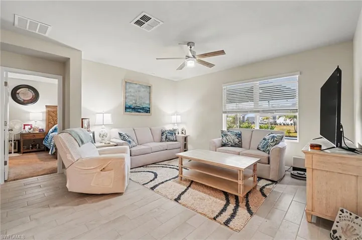 Living area featuring a ceiling fan and light wood-type flooring