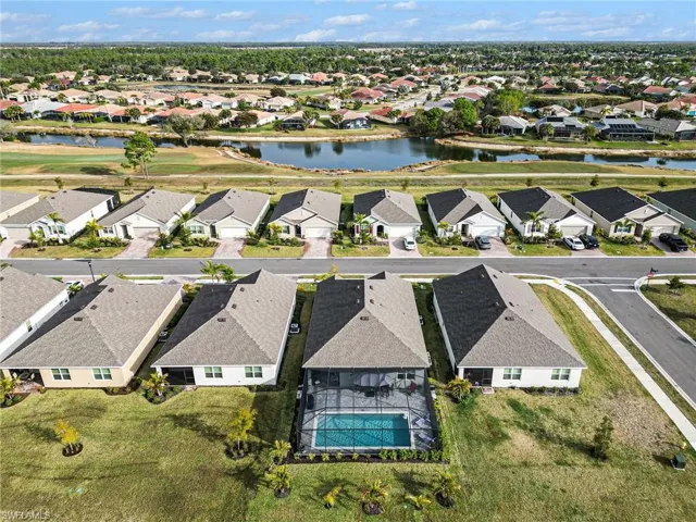 Aerial view of residential area featuring a nearby body of water