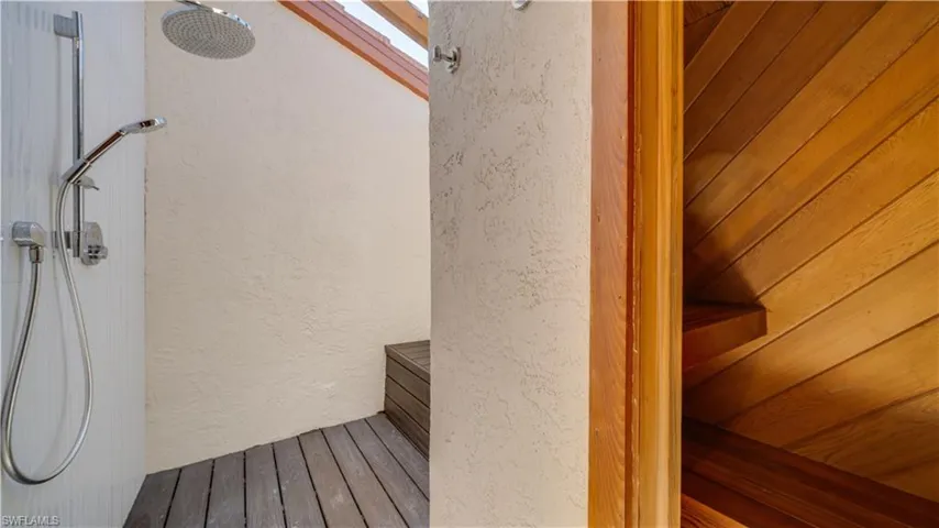 Sauna featuring a textured wall and wood finished floors