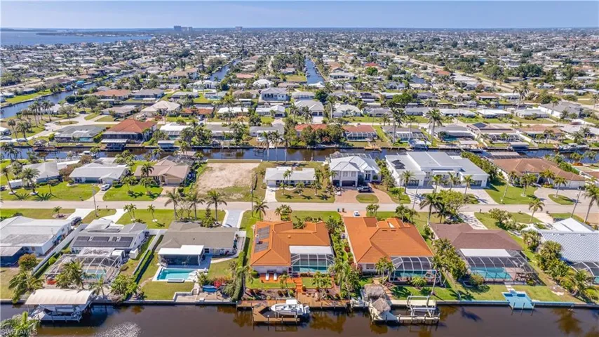 Aerial view of property's location with a large body of water and nearby suburban area