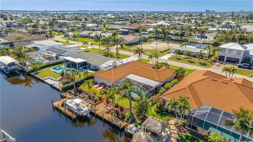 Aerial view of residential area featuring a nearby body of water