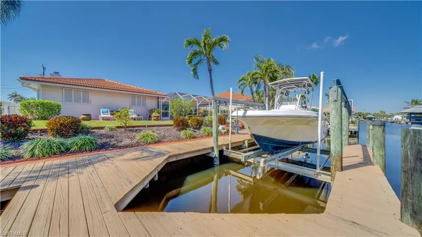 Dock area with boat lift and a water view