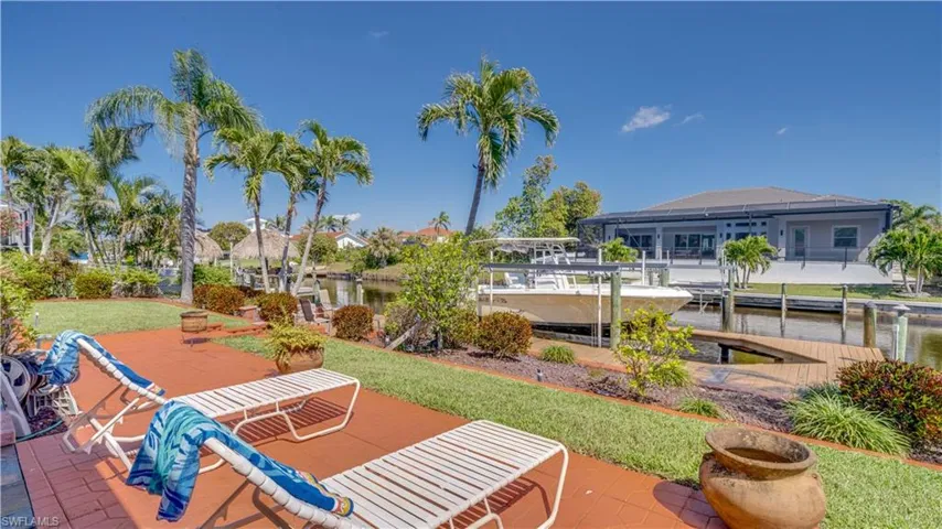 View of patio featuring a water view and a dock