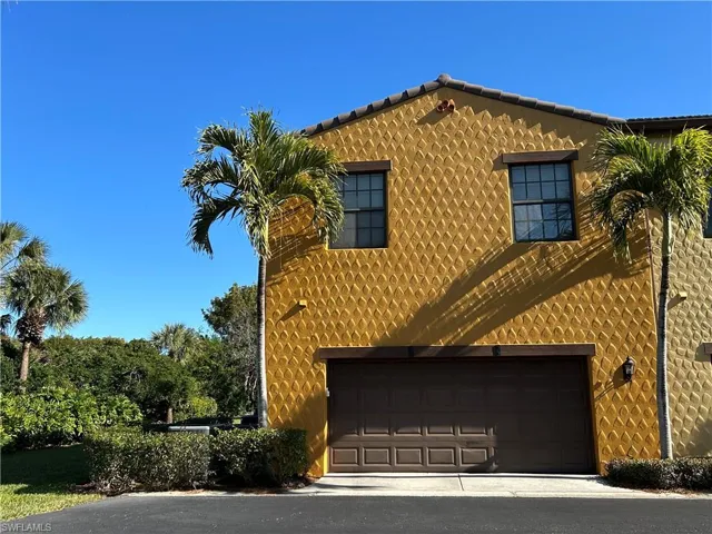 View of back of property with an attached garage
