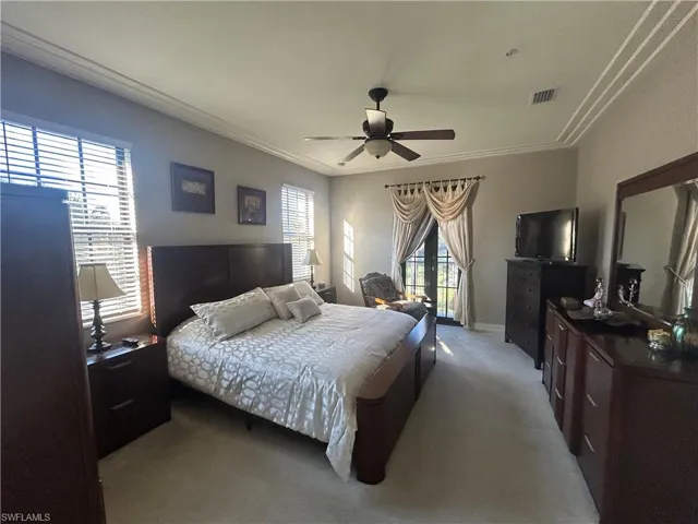 Master Bedroom featuring carpet floors, natural light, balcony, and ceiling fan