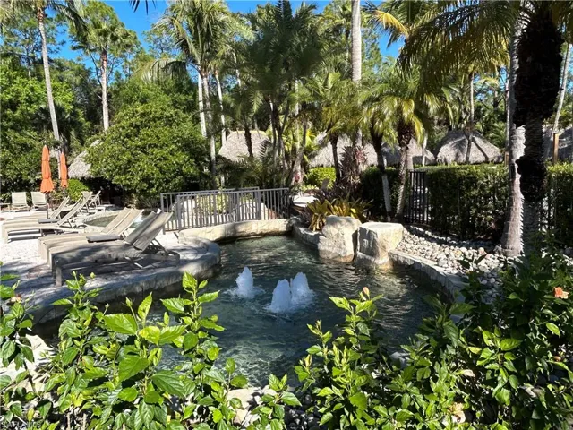 View of swimming pool with a garden pond