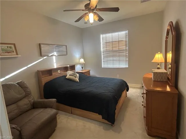 Carpeted bedroom with ceiling fan
