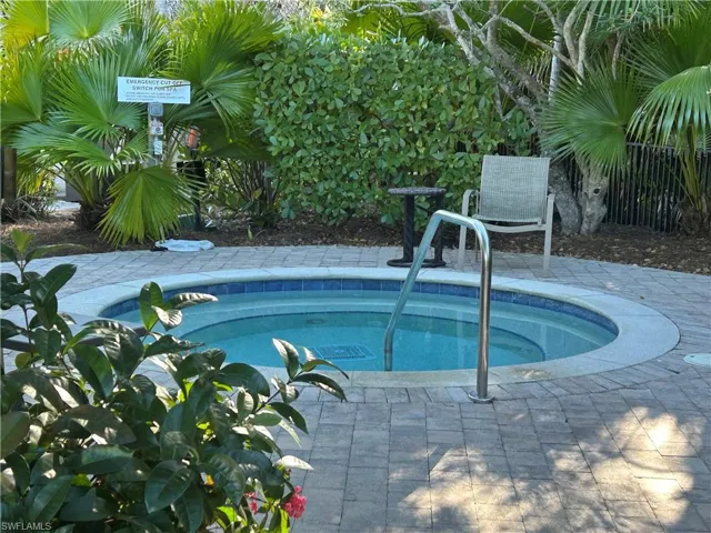 View of pool with a community hot tub and patio surround