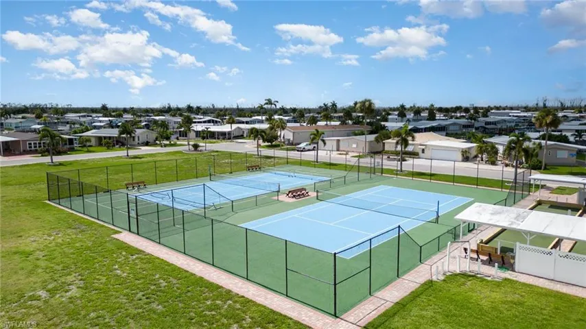 View of sport court featuring a yard