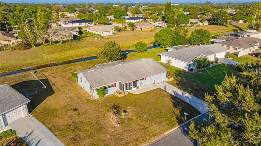 Aerial view of residential area featuring a tree filled landscape