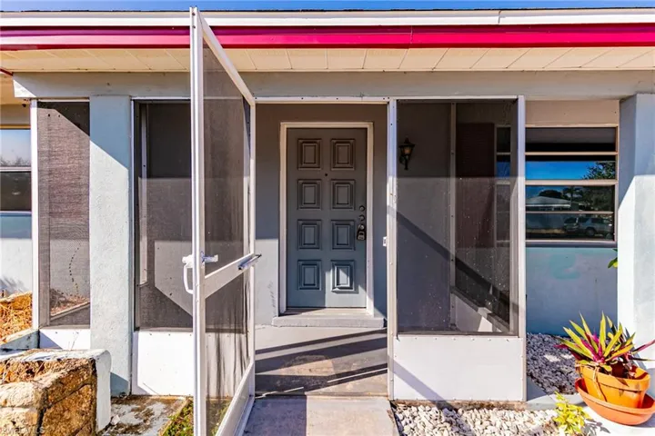 Property entrance with a sunroom