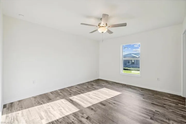Empty room featuring ceiling fan and wood-type flooring