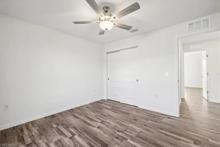 Spare room featuring ceiling fan and hardwood / wood-style floors