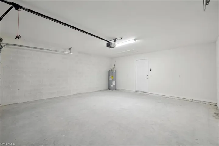 Garage with water heater and a garage door opener