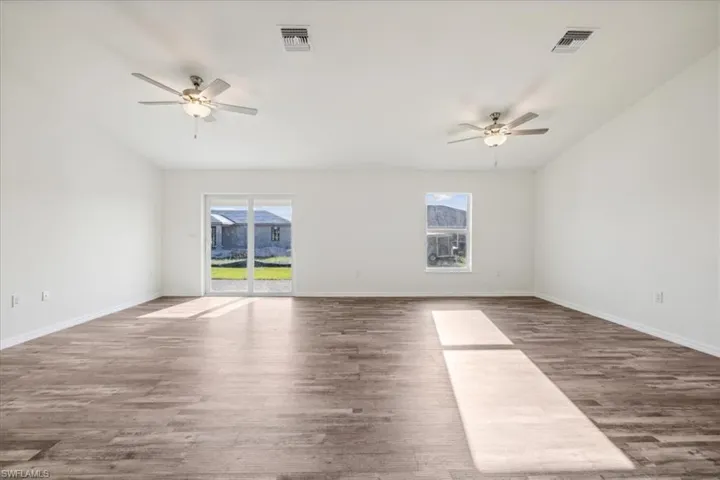 Unfurnished room with wood-type flooring and ceiling fan