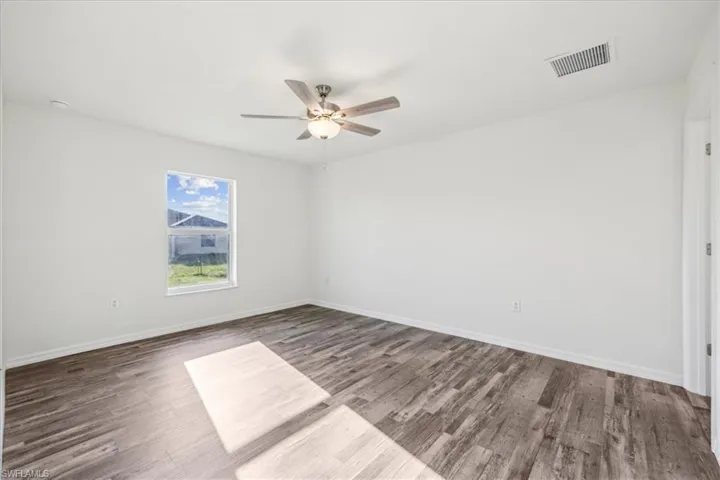 Unfurnished room with wood-type flooring and ceiling fan