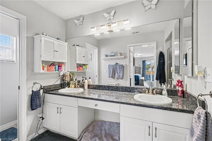 Full bathroom featuring double vanity and connected bathroom