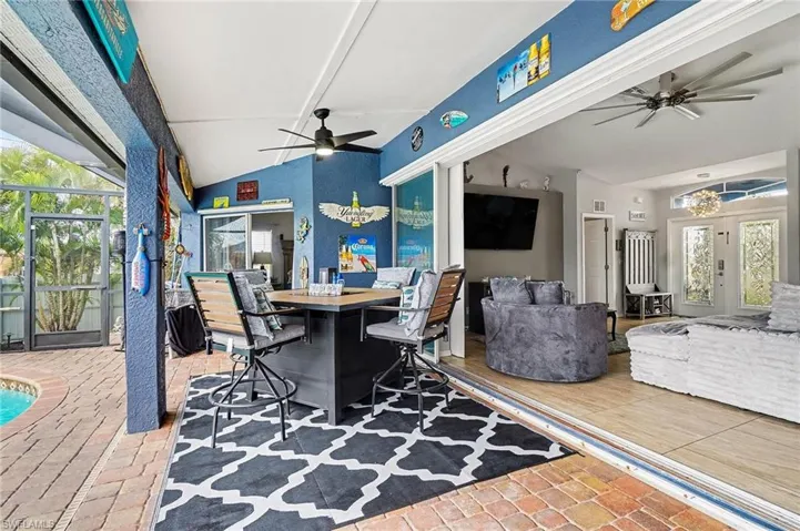 View of patio / terrace featuring ceiling fan, a lanai, and an outdoor pool