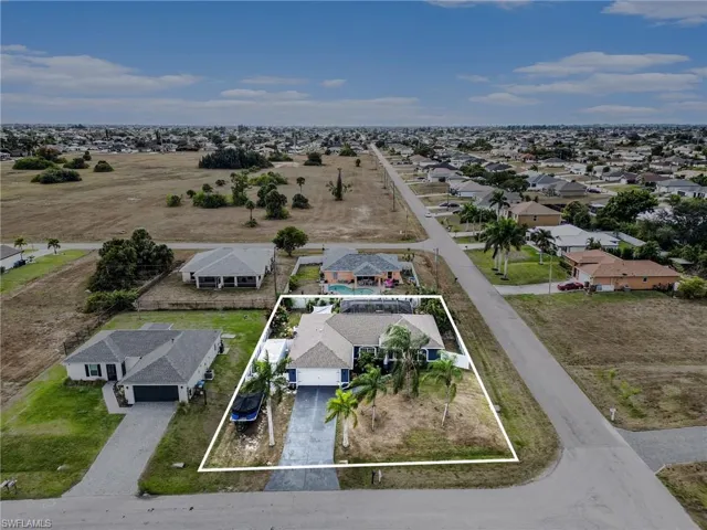 Aerial view of residential area with property boundaries highlighted
