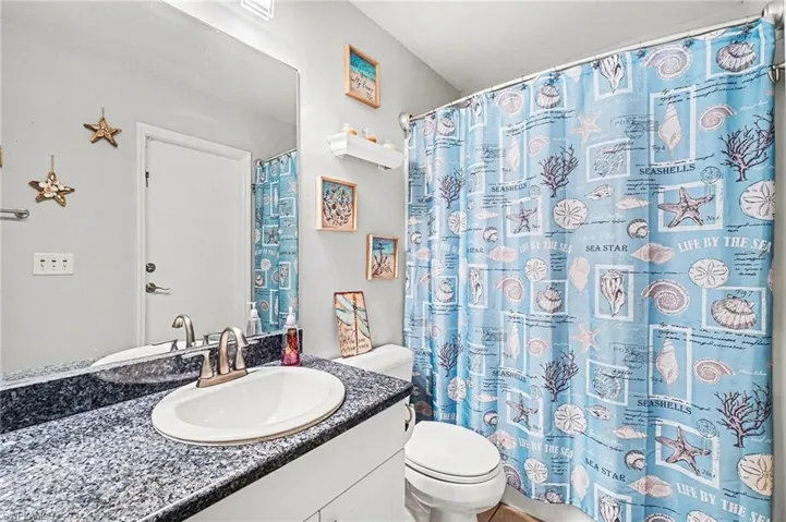 Bathroom featuring vanity and a shower with shower curtain